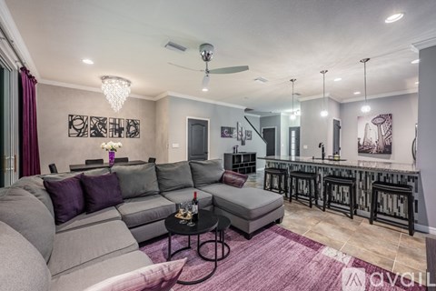 A modern living room with a grey sofa and a black coffee table.
