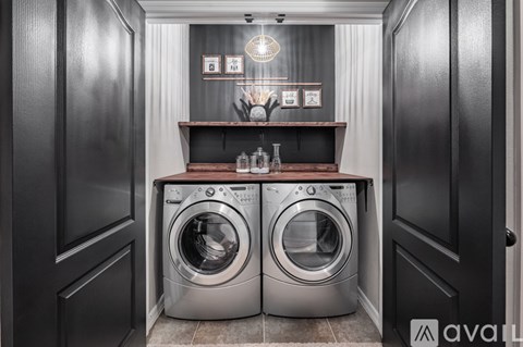 Two front-loading washing machines in a laundry room.