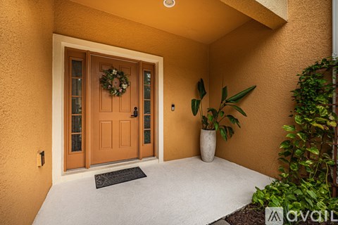 A brown door with a wreath on it is the main focus of this image.