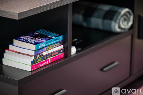 A stack of books by Jill Shalvis sits on a shelf.