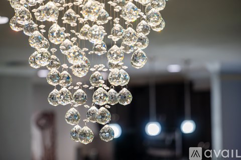 A chandelier with multiple crystal-like bulbs hanging from the ceiling.