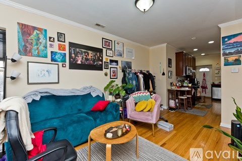 A living room with a blue couch and a coffee table.