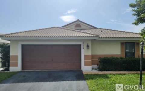 A house with a brown garage door is for sale.