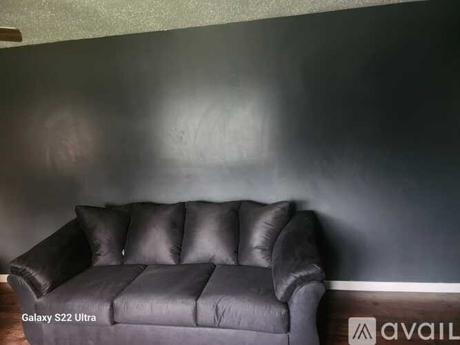 A black leather sofa with the text "Galaxy S22 Ultra" on it.