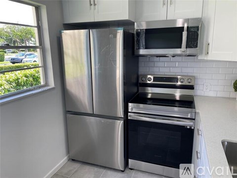 A kitchen with a stainless steel refrigerator and oven.
