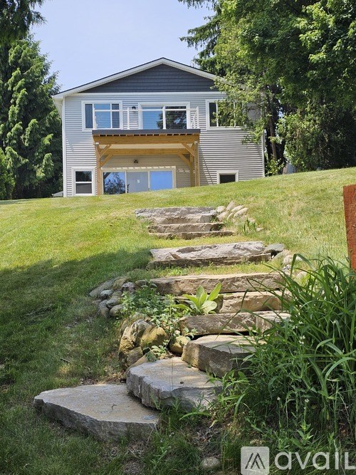A house with a stone staircase leading to the front door.