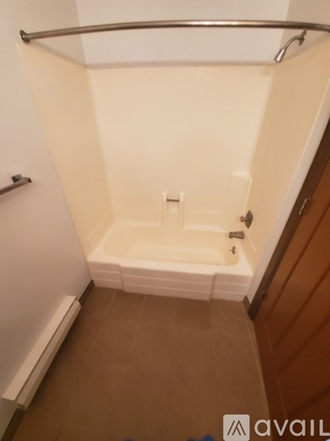 A bathroom with a toilet, sink, and mirror.
