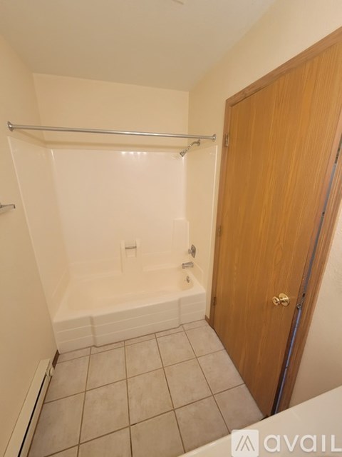 A small bathroom with a towel rack and a door.