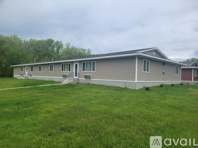 A two-story house with a grey and red exterior is available for rent.