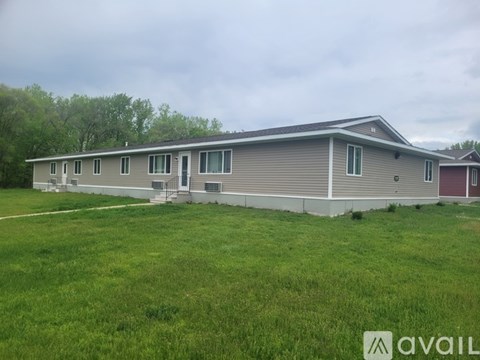 A two-story house with a grey and red exterior is available for rent.