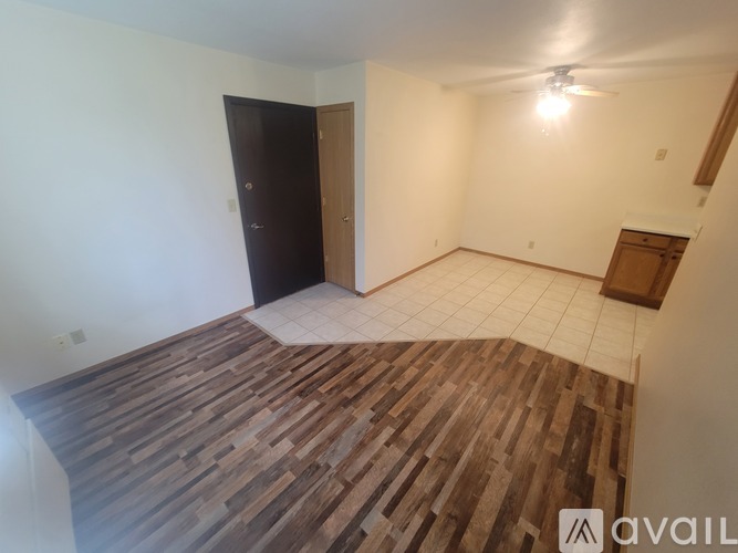 A room with a wooden floor and a ceiling fan.
