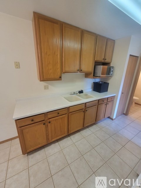 A kitchen with wooden cabinets and a white countertop.