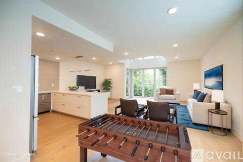 A foosball table is in the middle of a living room.