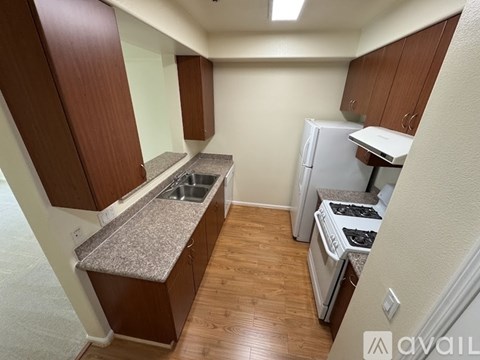 A kitchen with wooden cabinets and a granite countertop.