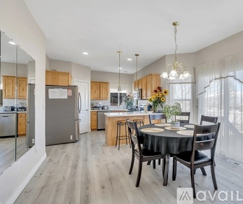 A modern kitchen with a dining table set for four.