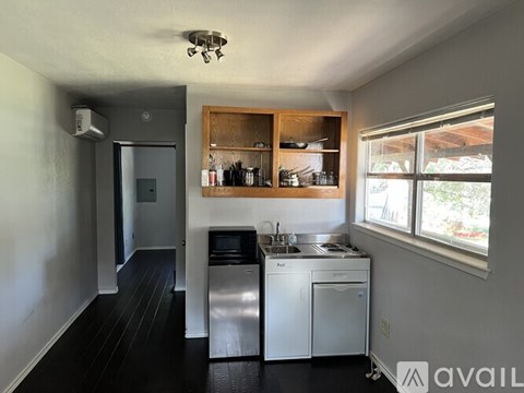 A kitchen with a stainless steel dishwasher and a sink.