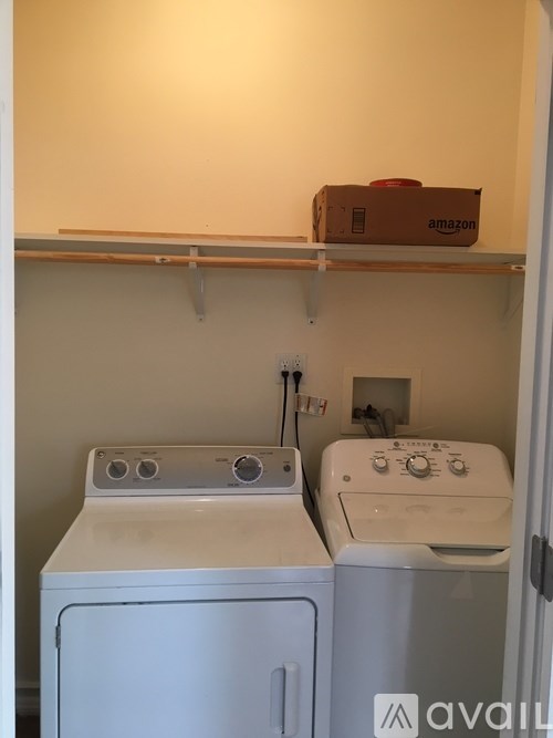 A small laundry room with a washer and dryer.