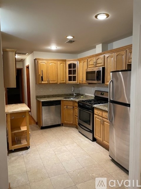 A kitchen with wooden cabinets and stainless steel appliances.