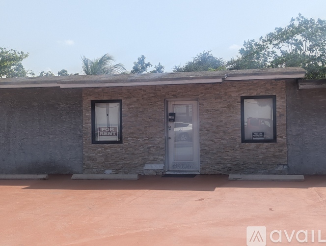 A house with a white door and windows is available for rent.