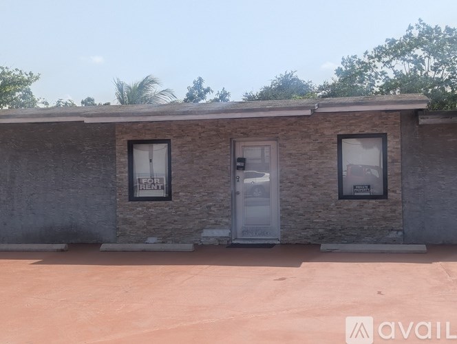 A house with a white door and windows is available for rent.