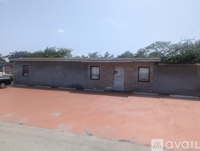 A building with a red ground and a car parked in front.