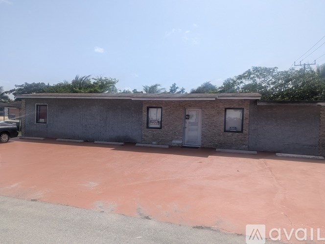 A building with a red ground and a car parked in front.