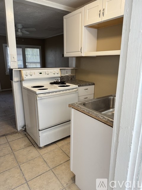 A white stove and sink in a kitchen.