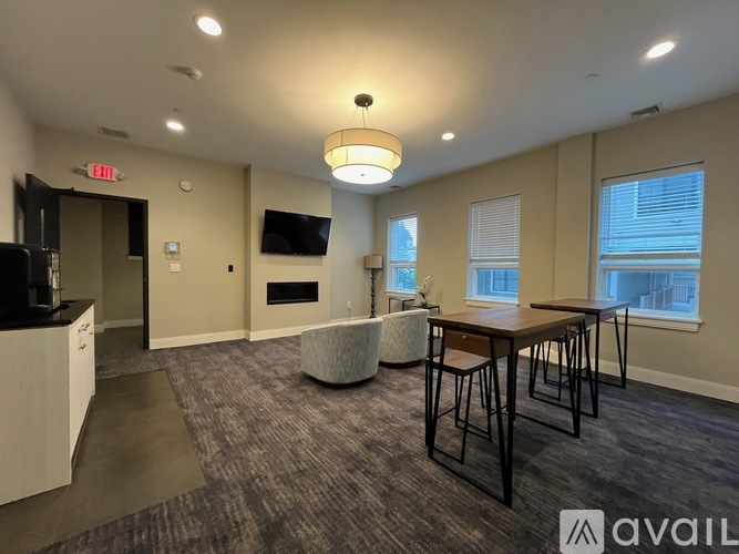 A spacious room with a bar area and seating.