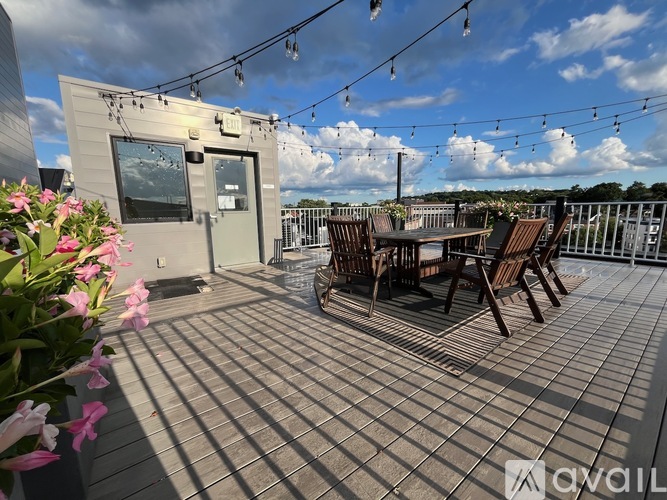 A patio with a table and chairs and a building in the background.