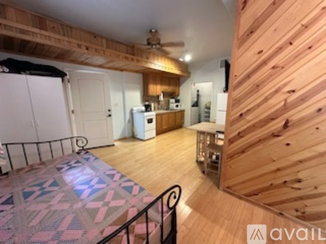 A kitchen area with a white fridge and a white door.