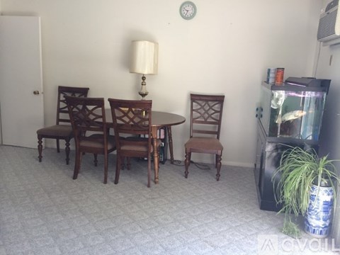 A living room with a table and chairs.