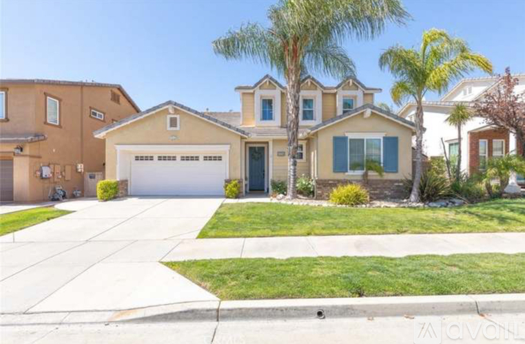 A house with a garage and a driveway in front of it.