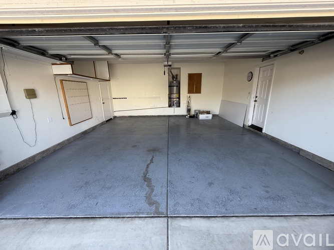 A spacious garage with a concrete floor and white walls.
