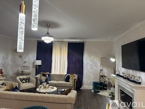 A living room with a white couch and a fireplace.