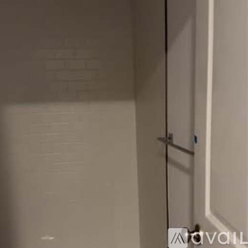 A white door with a handle and a small blue tag on it.