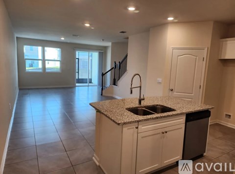 A kitchen with a sink and a window.
