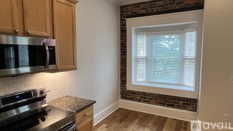 A kitchen with a stove top oven and microwave above it.