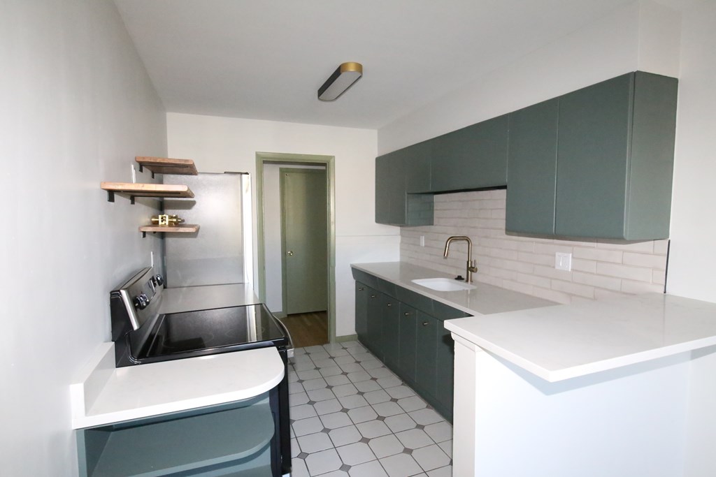 A kitchen with a sink and a counter.