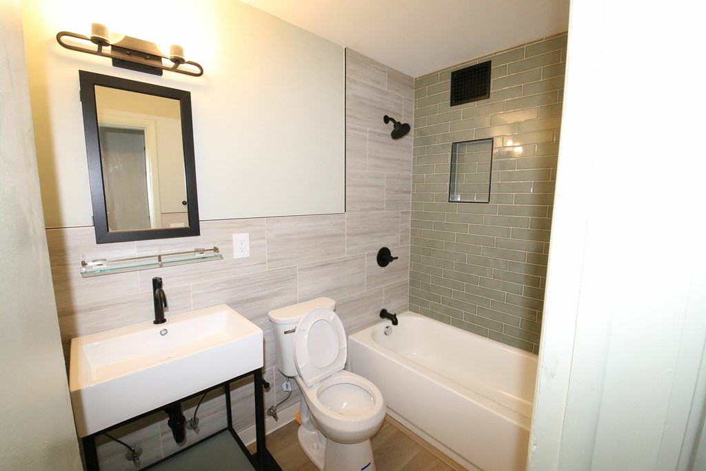 A white sink and toilet in a bathroom.