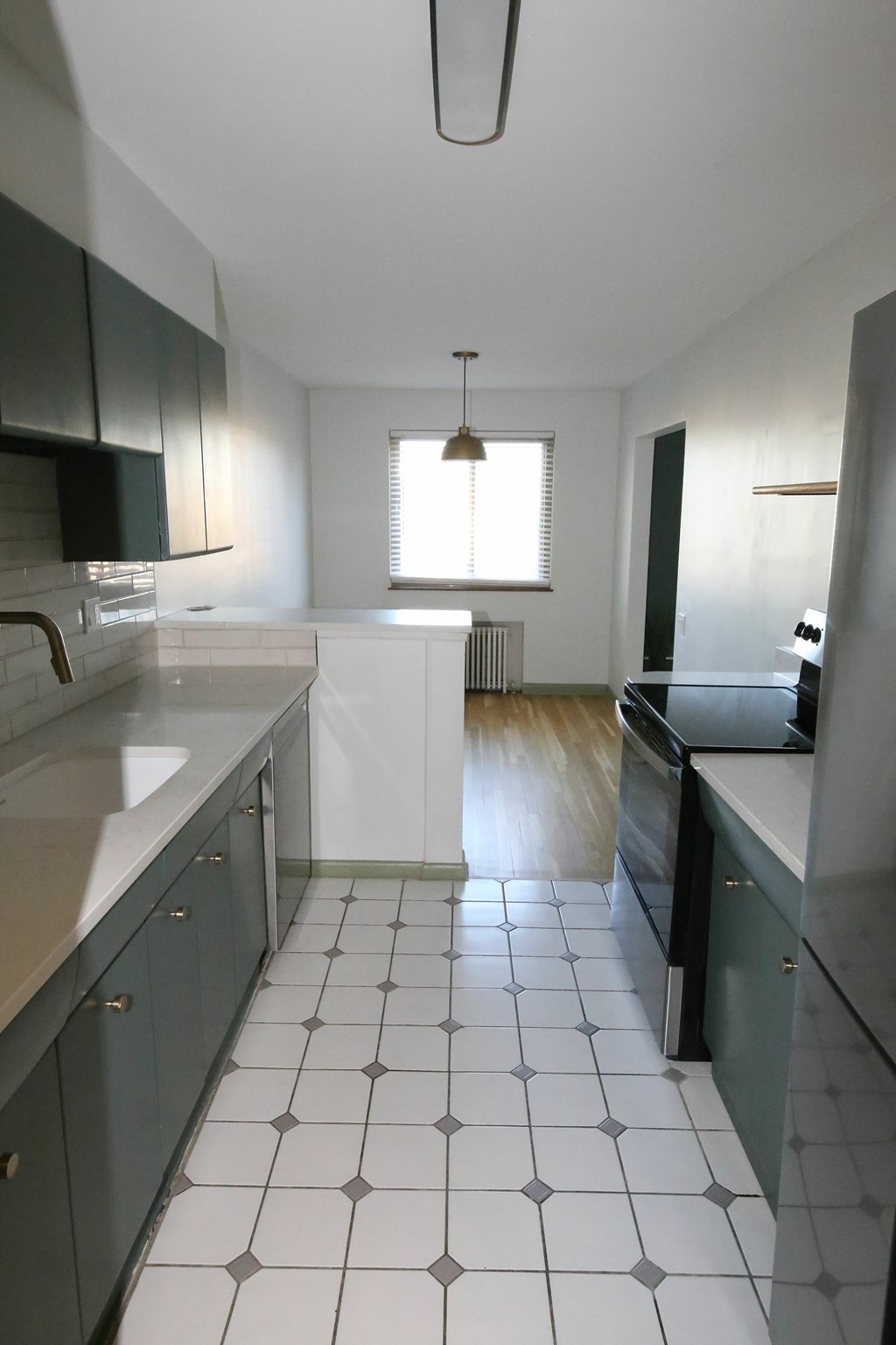 A kitchen with black and white tiles.