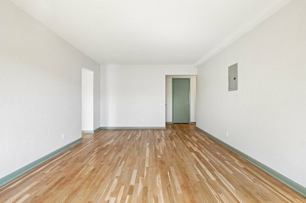 A bathroom with a poster on the wall and a radiator below it.