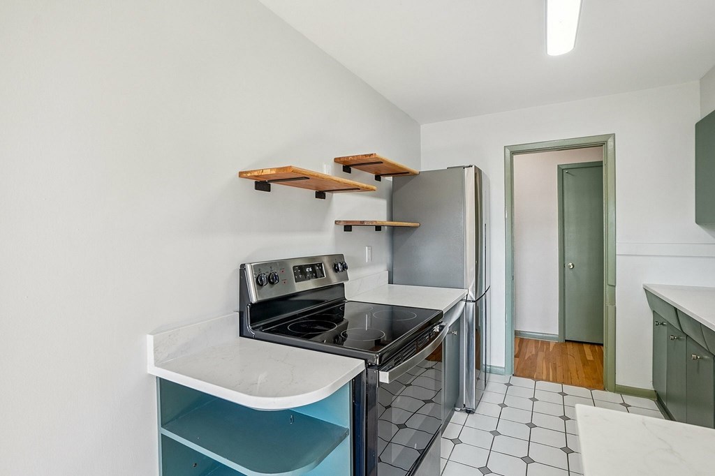A kitchen with a stove, oven, and sink.