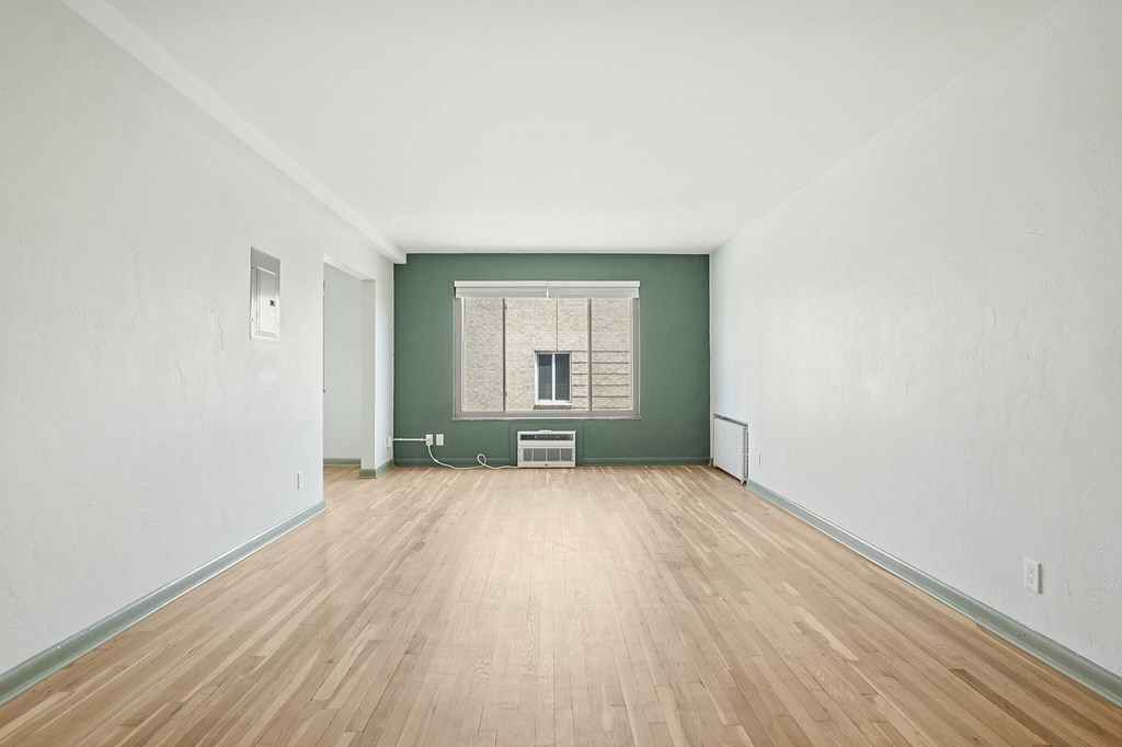 A room with wooden floors and white walls.