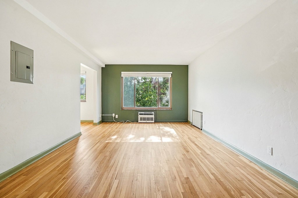 A room with wooden floors and a window.