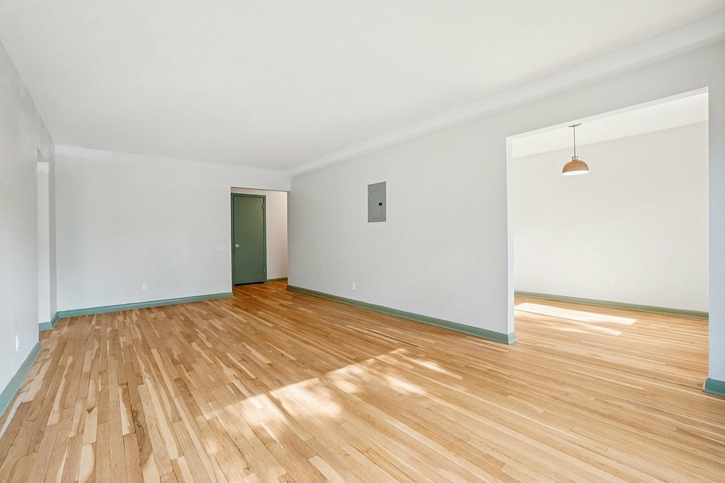 A room with wooden floors and white walls.