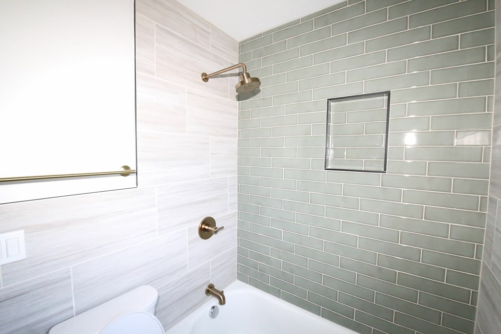 A bathroom with a white toilet and a shower with a glass door.