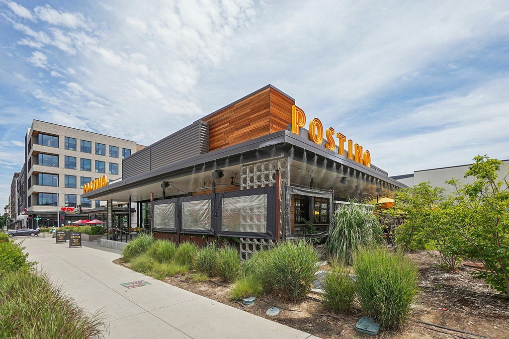 A Postino restaurant with a wooden facade and a sign above the entrance.