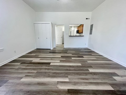 A room with a wooden floor and white walls.