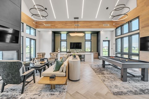A modern living room with a pool table and a fireplace.