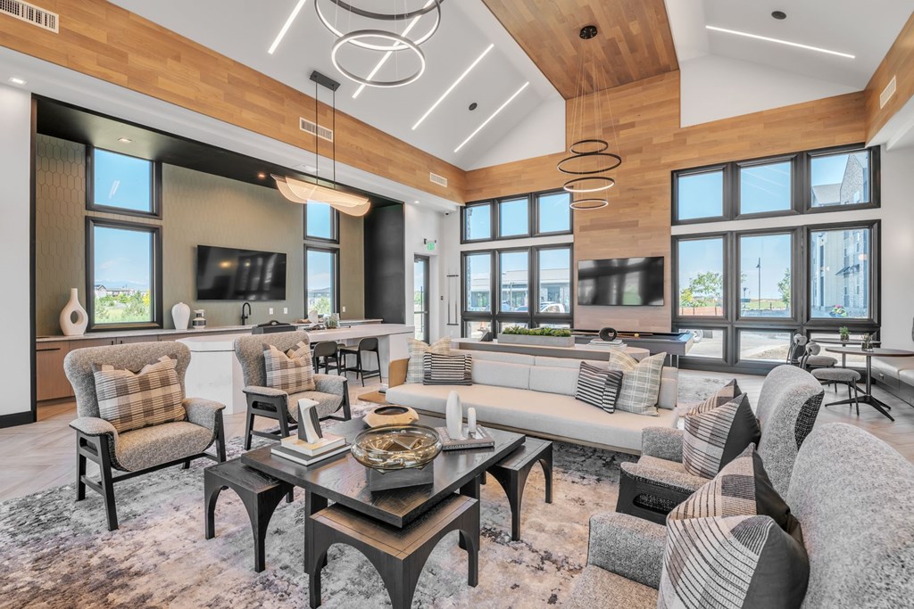 A modern living room with a wooden ceiling and a large window.